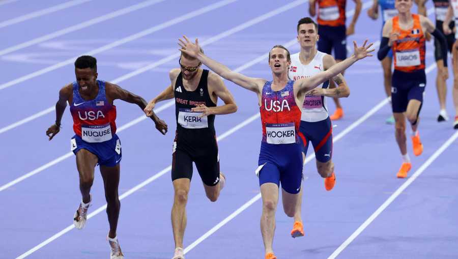 PARIS, FRANCE - AUGUST 06: (L-R)  Bronze medalist Yared Nuguse of Team United States , silver medalist Josh Kerr of Team Great Britain and gold medalist Cole Hocker of Team United States cross the finish line during the Men&apos;s 1500m Final on day eleven of the Olympic Games Paris 2024 at Stade de France on August 06, 2024 in Paris, France. (Photo by Steph Chambers/Getty Images)