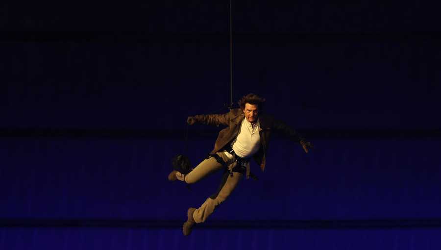 US&apos; actor Tom Cruise lands on the roof of one of the stadium entrances during the closing ceremony of the Paris 2024 Olympic Games at the Stade de France, in Saint-Denis, in the outskirts of Paris, on August 11, 2024. (Photo by Franck FIFE / AFP) (Photo by FRANCK FIFE/AFP via Getty Images)