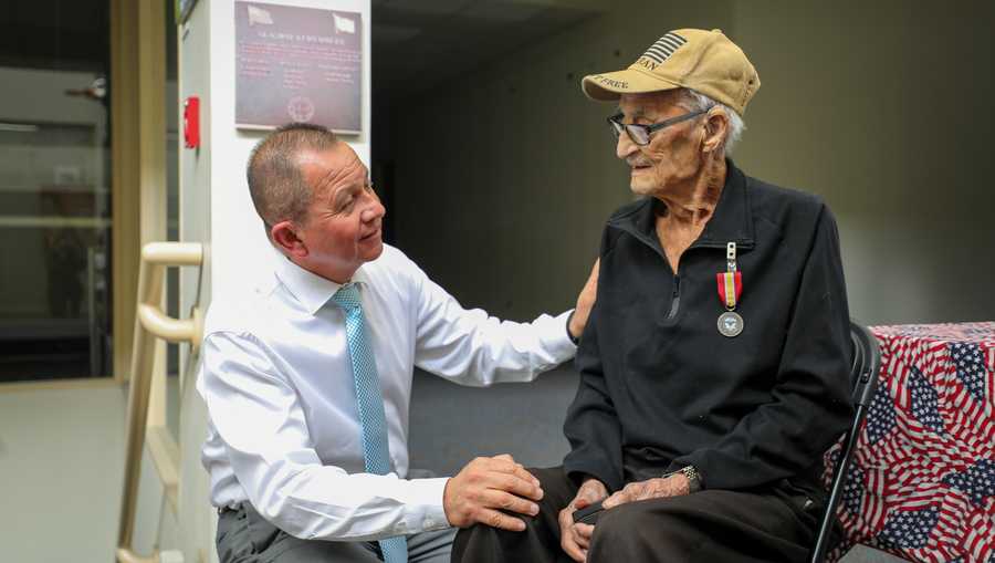 Francisco Hurtado, Alaska Veterans Affairs Healthcare System, left, thanks U.S. Army Technician Third Grade Louis M. Gigliotti for his honorable service during a ceremony at the Alaska Veterans Museum in Anchorage, July 19, 2024.